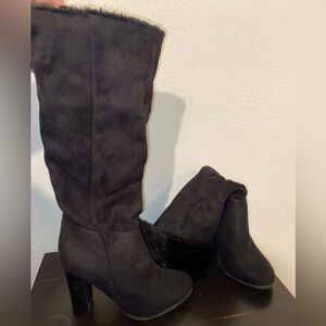 Long thick black high heeled boots with some fur on the inside